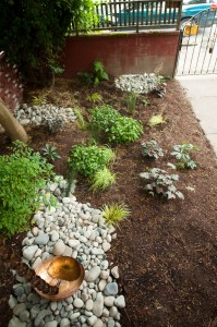 This beautiful copper rain chain and bowl replaced a standard downspout.